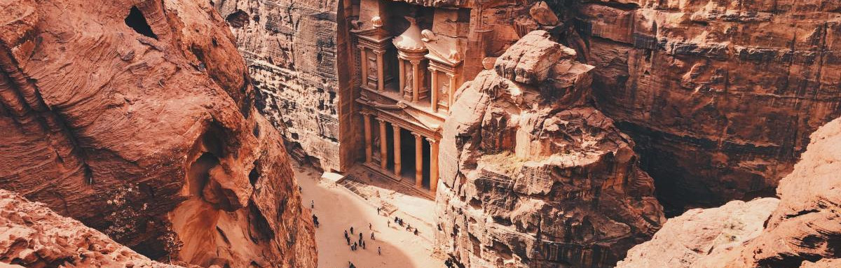 Archeological city of Petra within red rock formations.