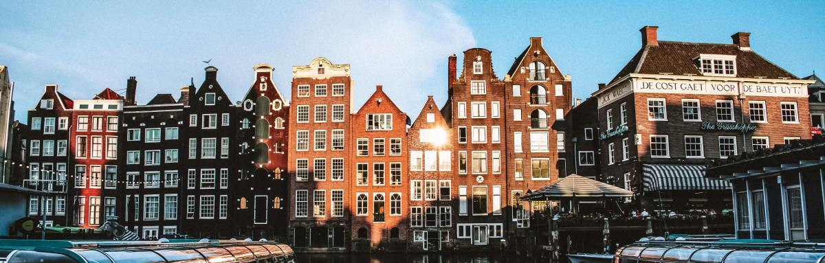 Brick buildings overlooking the water on a sunny day in Europe