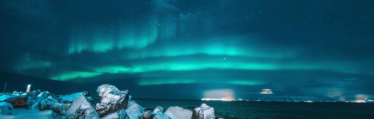 The northern lights shining over a glacier in Iceland