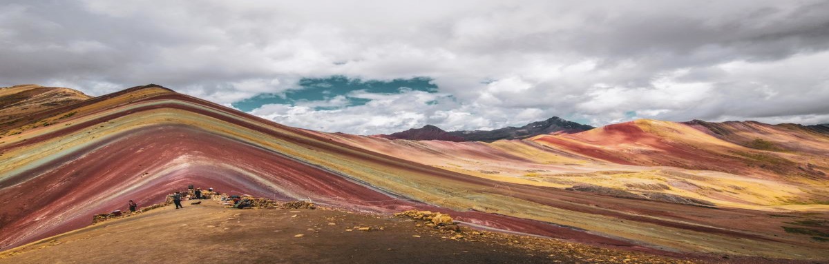 Rainbow Mountain in Cusco, Peru on a bright and cloudy day.