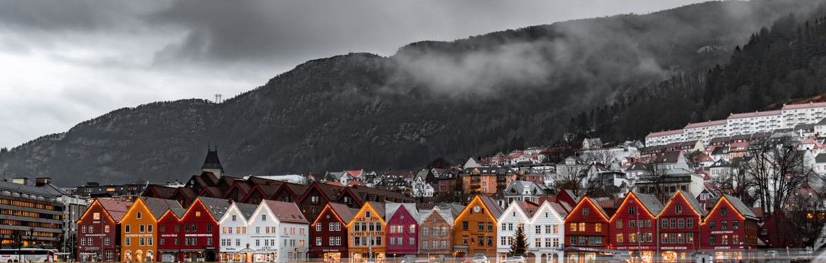 Historic buildings with holiday lights during cozy winter in Norway.