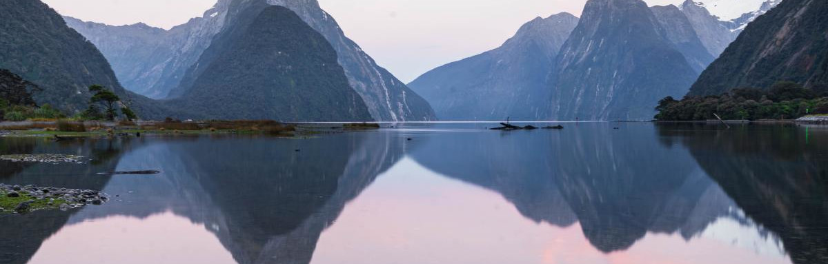 Mountains over lake with reflection during dusk in New Zealand.