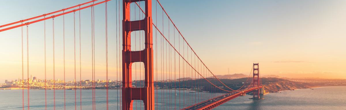 Golden Gate bridge over ocean during sunset in California.